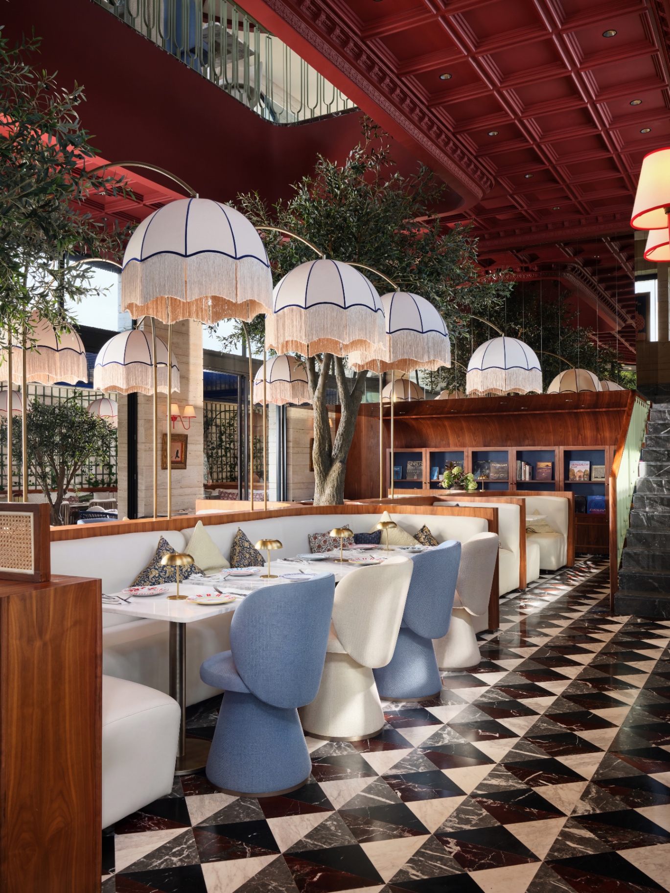 Beyti main dining hall under fringed parasol lamps with olive trees and checkerboard marble floor